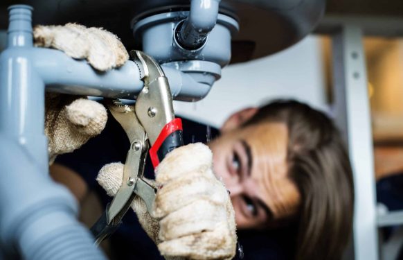 Man fixing kitchen sink